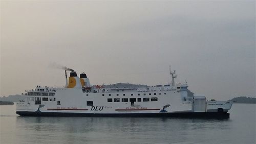 Ship sailing on sea against sky