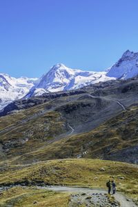 Scenic view of snow covered mountains against clear sky