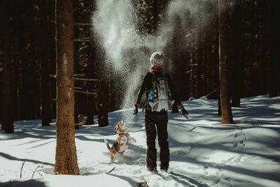 View of dog on snow covered landscape during winter