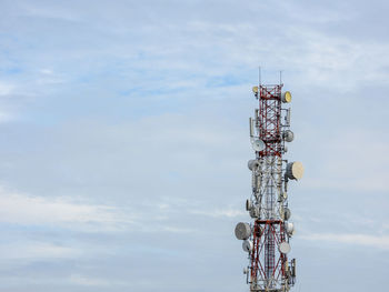 Low angle view of communications tower against sky