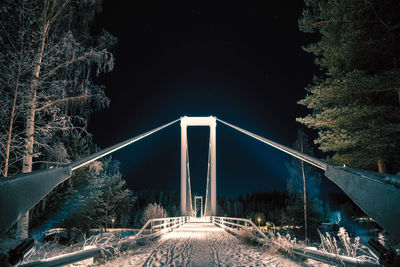 Bridge against sky during winter at night