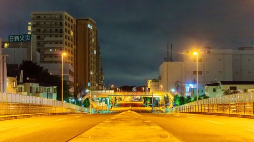 Illuminated city street at night