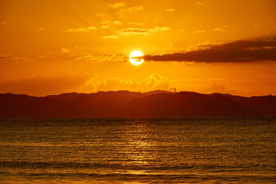 Scenic view of sea against orange sky