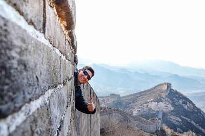 Man on rock against mountains
