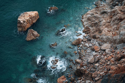 High angle view of rocks in sea