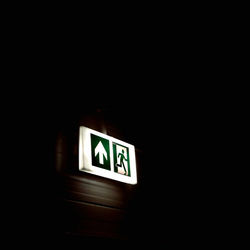 Low angle view of information sign in darkroom