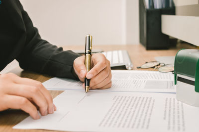 Midsection of man working on table