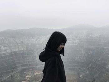 Portrait of woman on snow covered landscape