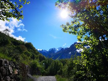 Scenic view of mountains against sky on sunny day