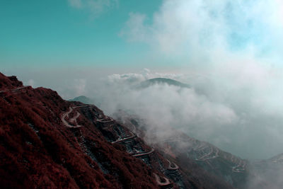 View of volcanic landscape against cloudy sky