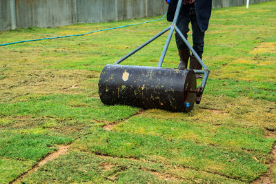 Low section of person standing on field