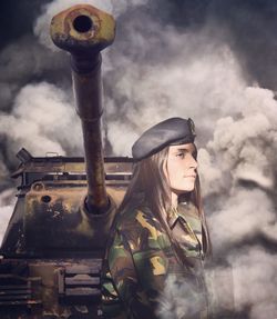 Close-up of woman standing against cloudy sky