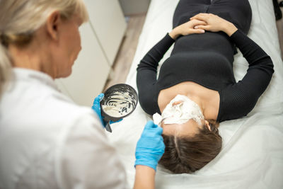 Side view of doctor examining patient at clinic