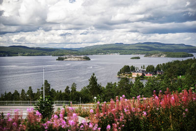 Scenic view of sea and mountains against sky