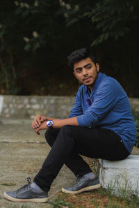 Portrait of young man sitting outdoors