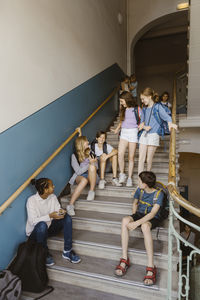 Male and female students on staircase during recess at school