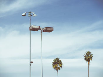 Low angle view of street lights against sky