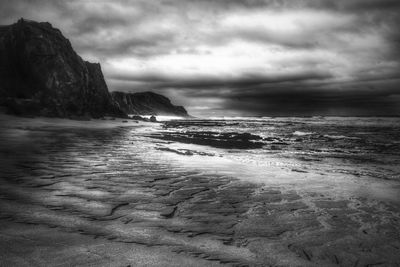 Scenic view of sea against cloudy sky