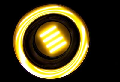 Close-up of illuminated light over black background