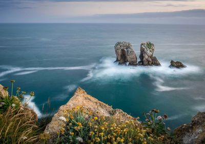 Scenic view of sea against cloudy sky