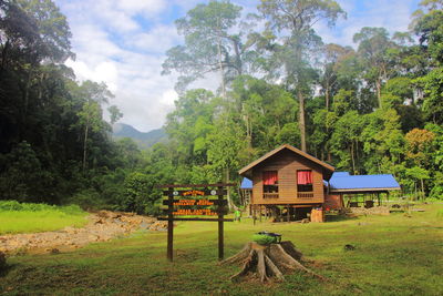 Gazebo by trees on mountain against sky