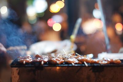 Close-up of illuminated candles at market stall