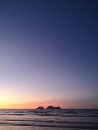 Scenic view of sea against clear sky during sunset