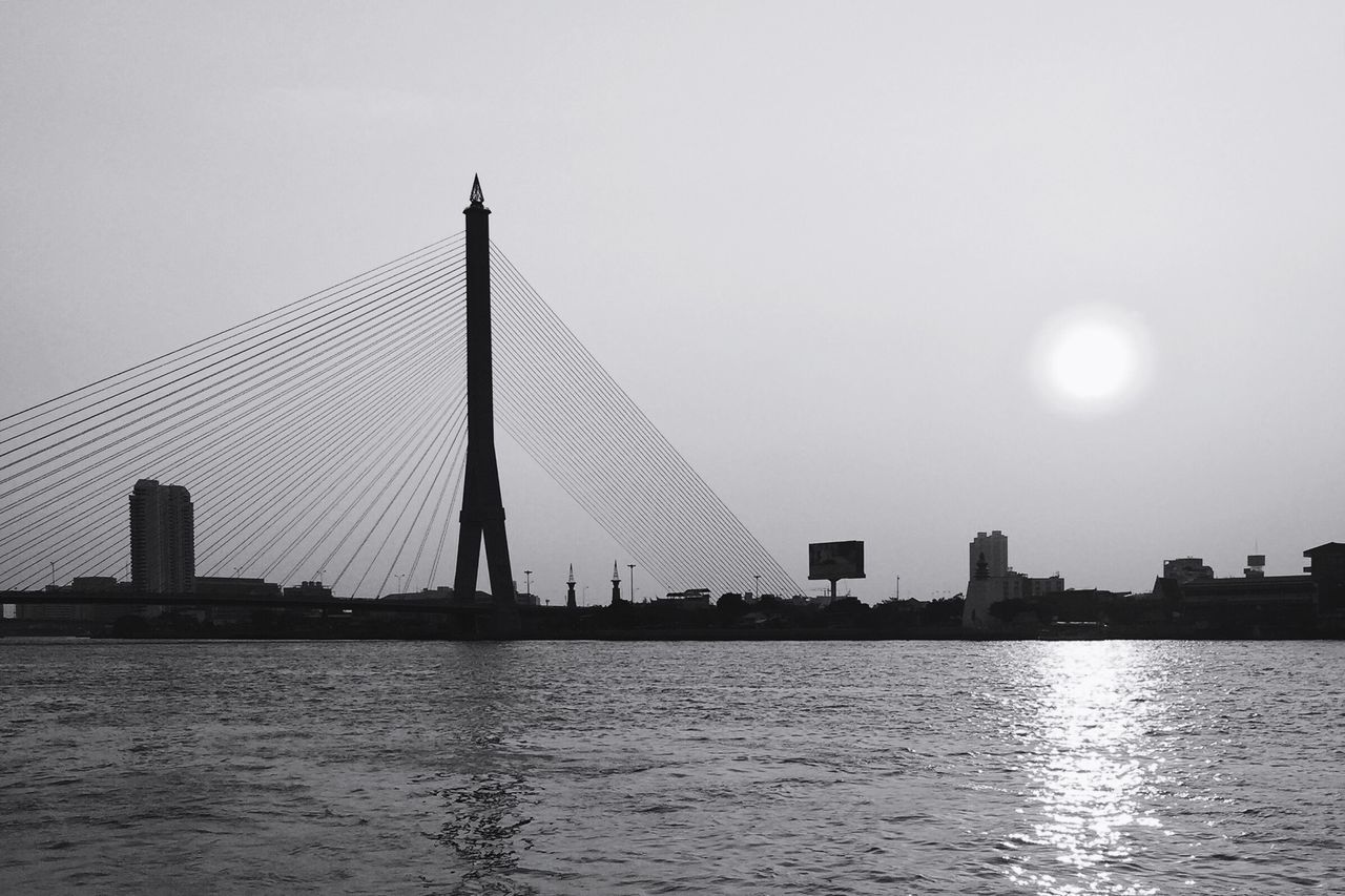 architecture, built structure, water, waterfront, building exterior, silhouette, city, river, sunset, bridge - man made structure, connection, clear sky, sky, reflection, sea, sun, travel destinations, rippled, engineering, famous place