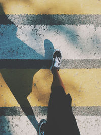 Low section of man standing on street