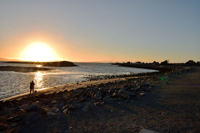 Scenic view of sea against clear sky during sunset