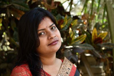 Portrait of woman against plants