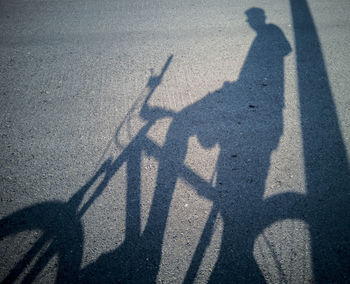 Shadow of people on road in city