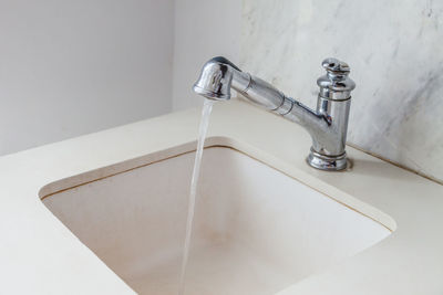 Close-up of faucet in bathroom