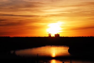 Scenic view of lake against orange sky