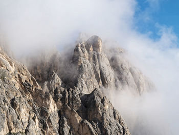 Smoke emitting from volcanic mountain against sky