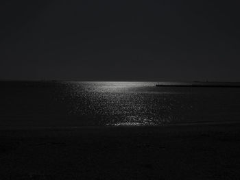 Scenic view of sea against clear sky at night