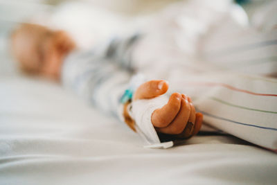 Baby child hand with iv sick at the hospital with a virus coronavirus