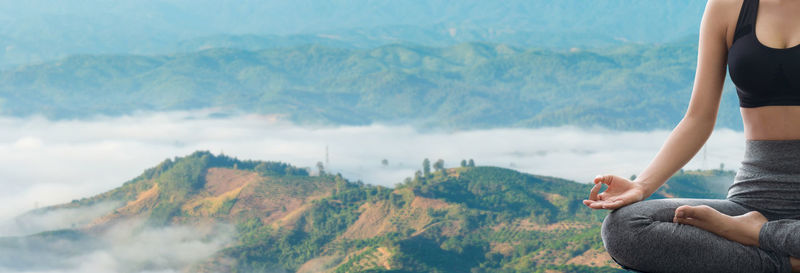 Rear view of woman standing on mountain