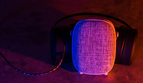 Close-up of speaker on illuminated table