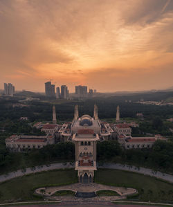 Buildings against sky during sunset in city