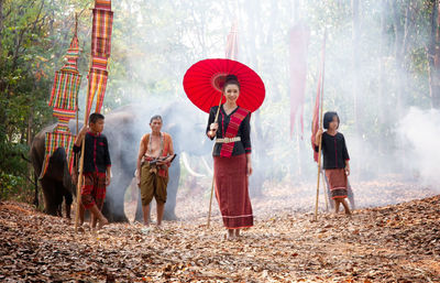 Group of people standing in forest