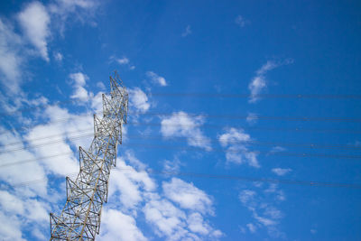 Low angle view of vapor trail against blue sky