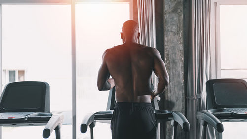 Rear view of woman standing in gym