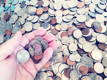 Cropped hand of woman holding coins