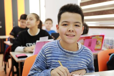 Portrait of boy sitting on table