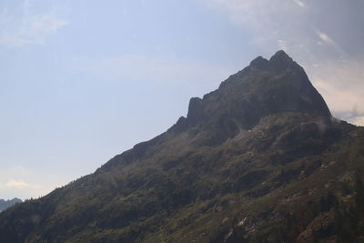 Low angle view of rocky mountains against sky