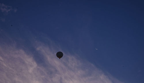 Low angle view of hot air balloon against blue sky