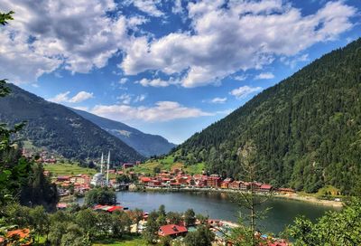 Scenic view of lake and mountains against sky