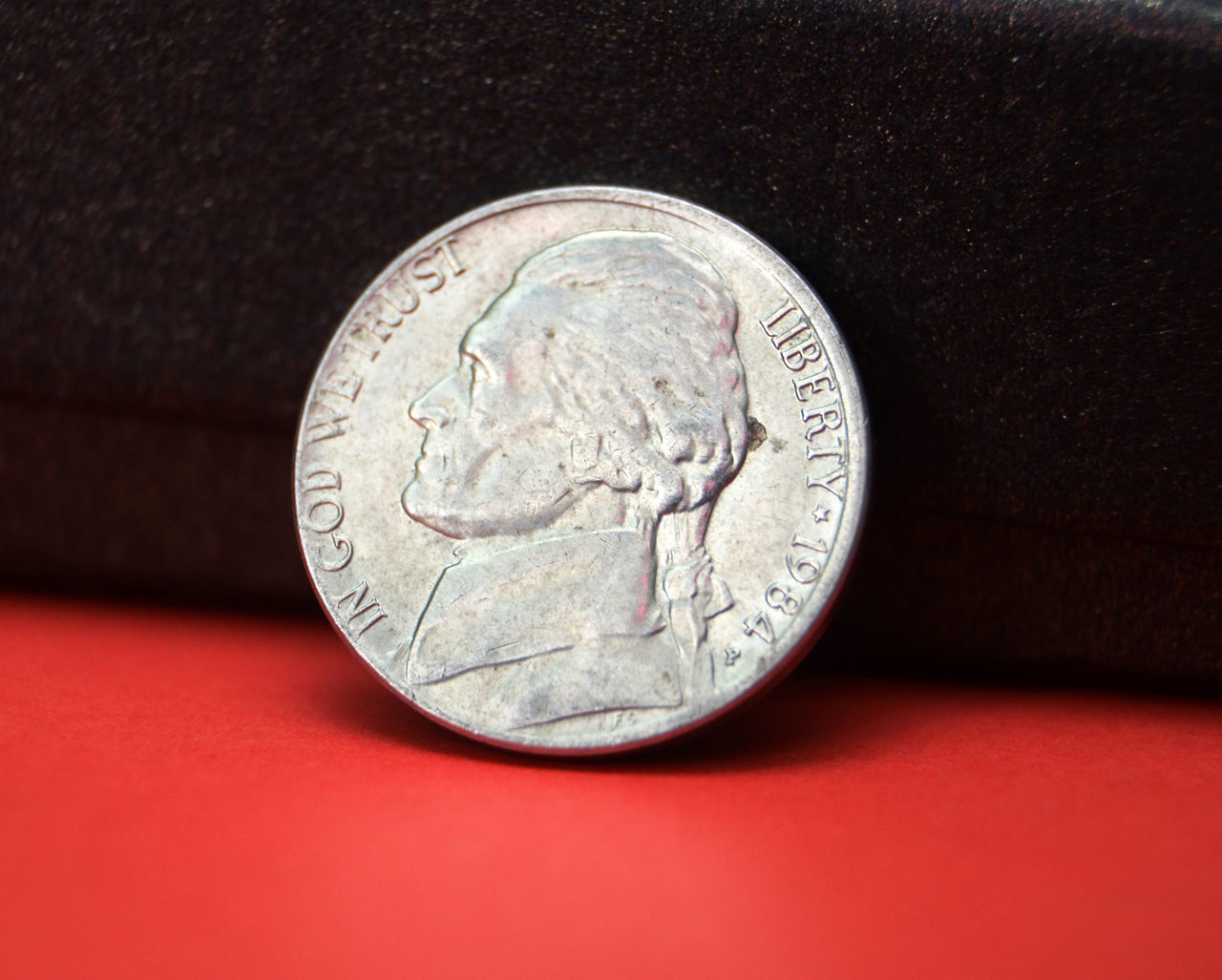 CLOSE-UP OF COIN ON THE BACKGROUND