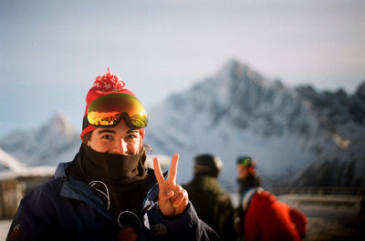 Portrait of man holding ice cream against sky